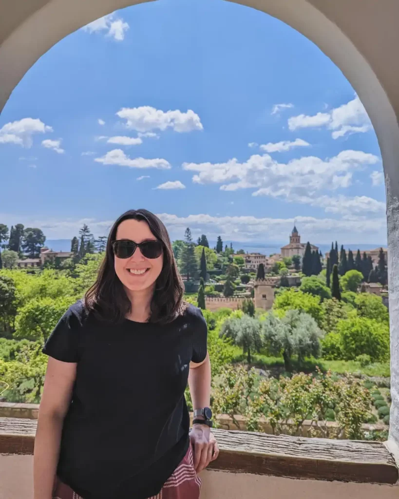 A picture of me (Helen) in front of the Alhambra in Granada, one of my favourite day trips from Málaga