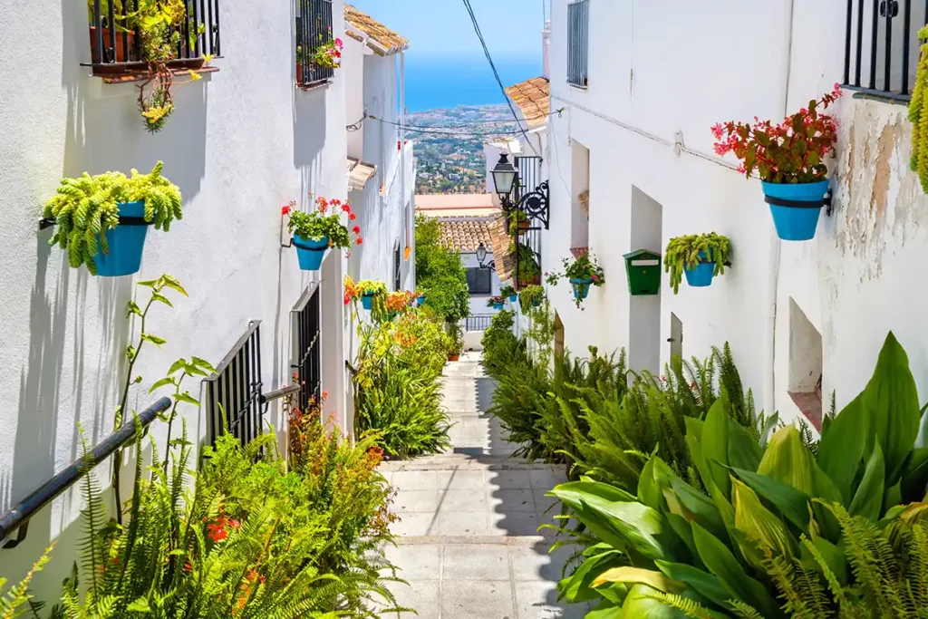 A whitewashed street in an Andalusian village, looking down towards the sea