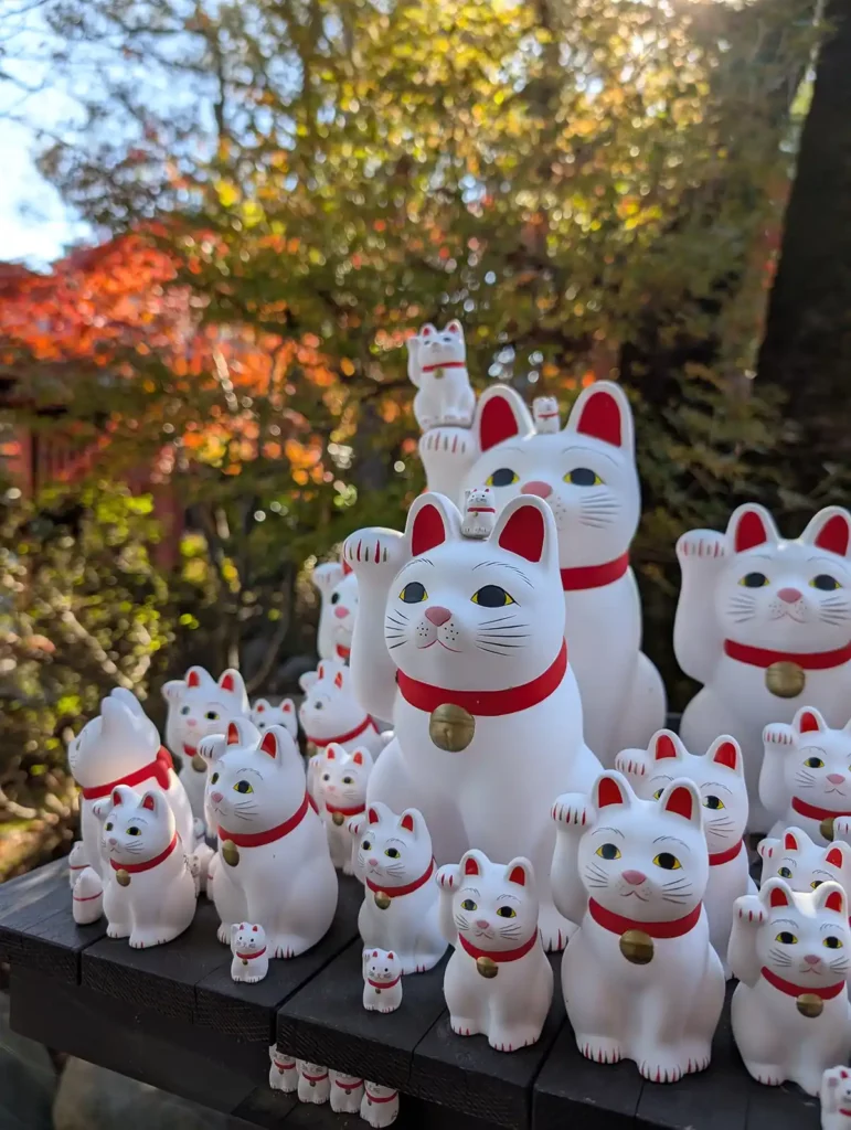 A group of cat sculptures at Gotokuji Cat Temple in Tokyo