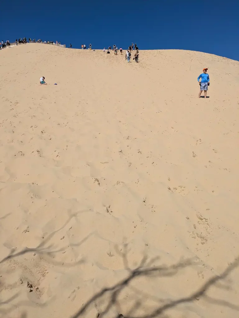 Standing at the bottom of an enormous sand dune