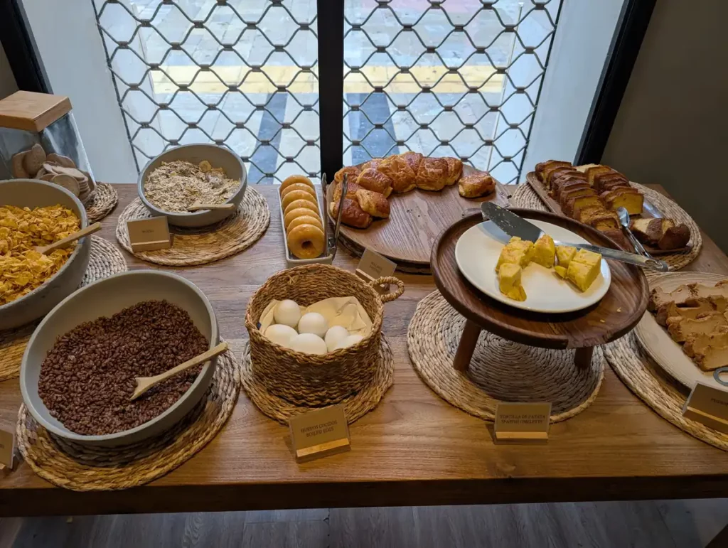 A breakfast buffet, including cakes and Spanish tortilla