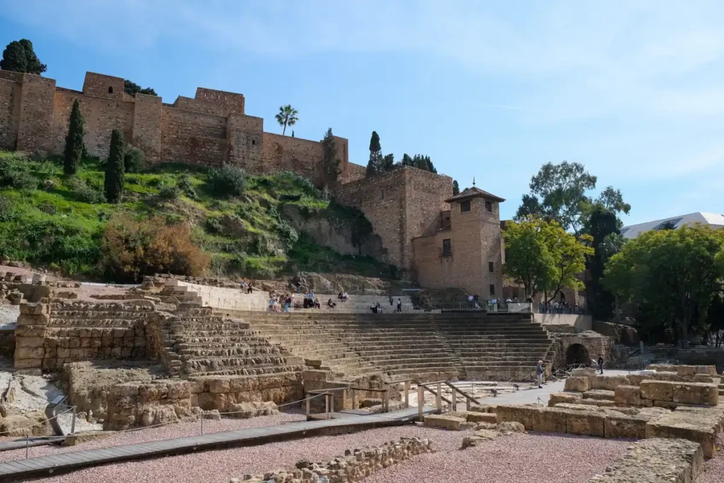 A Roman amphitheatre in Malaga with the castle walls of the Alcazaba behind