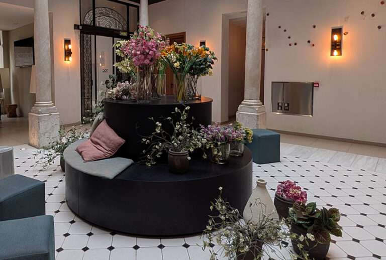 The flower-filled reception area at TOC Hostel Malaga. This TOC Hostel Malaga review will help you decide whether you should book.