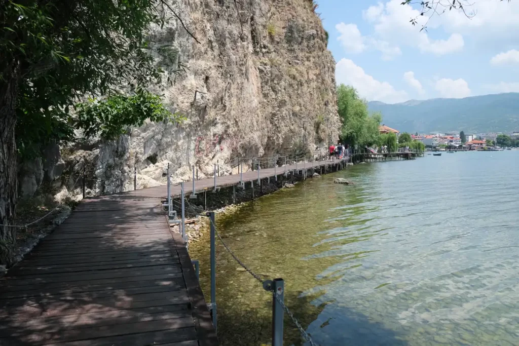 Looking back along the boardwalk towards Ohrid old town from Potpesh Beach. There's a high cliff above the boardwalk.