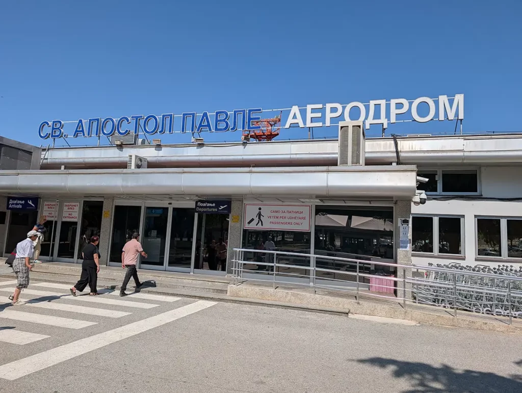 A small airport terminal with the name written in Cyrillic text above the doors
