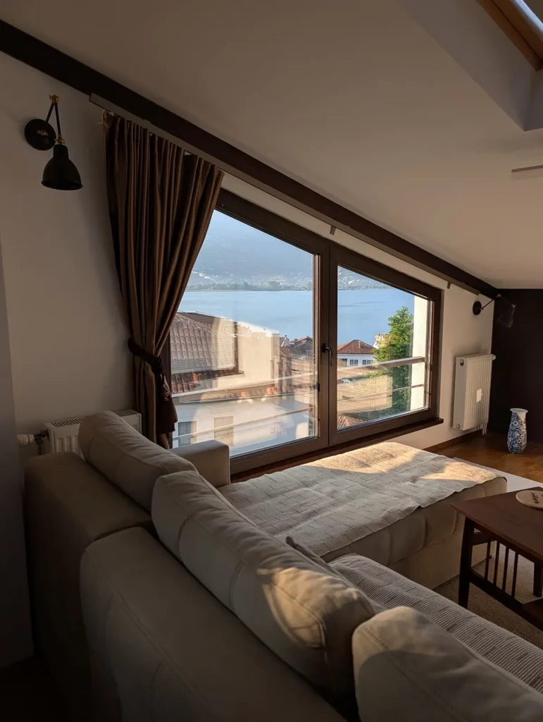 A sofa with a view of the lake