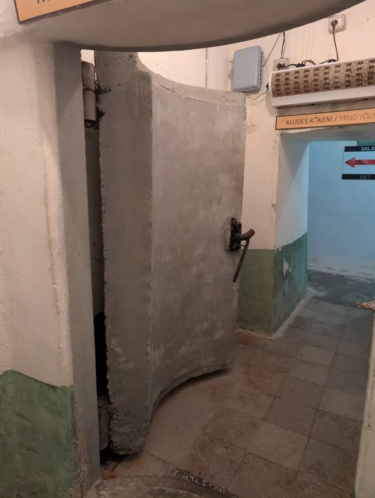 A curved concrete blast door at Bunk'Art 1