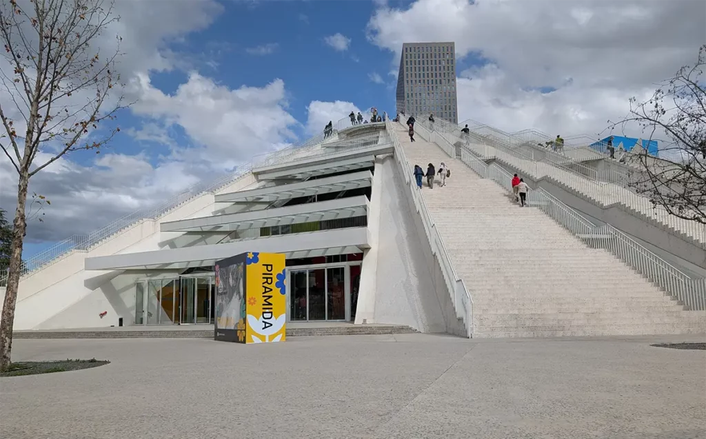 People walking up the stepped, concrete sides of Tirana Pyramid, another relic of the Hoxha regime