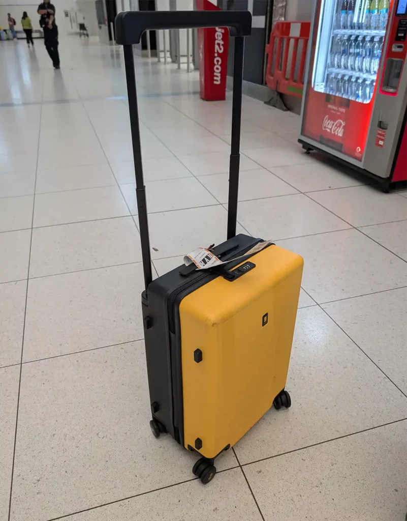 A yellow suitcase in an airport