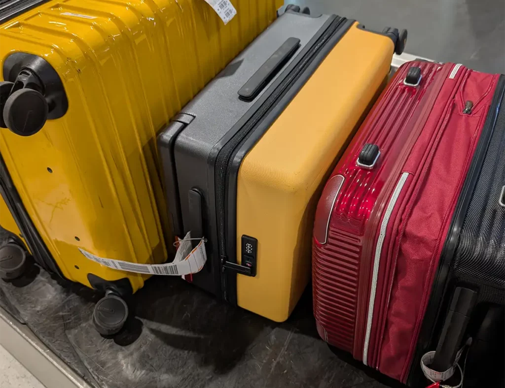 A yellow suitcase on an airport luggage belt