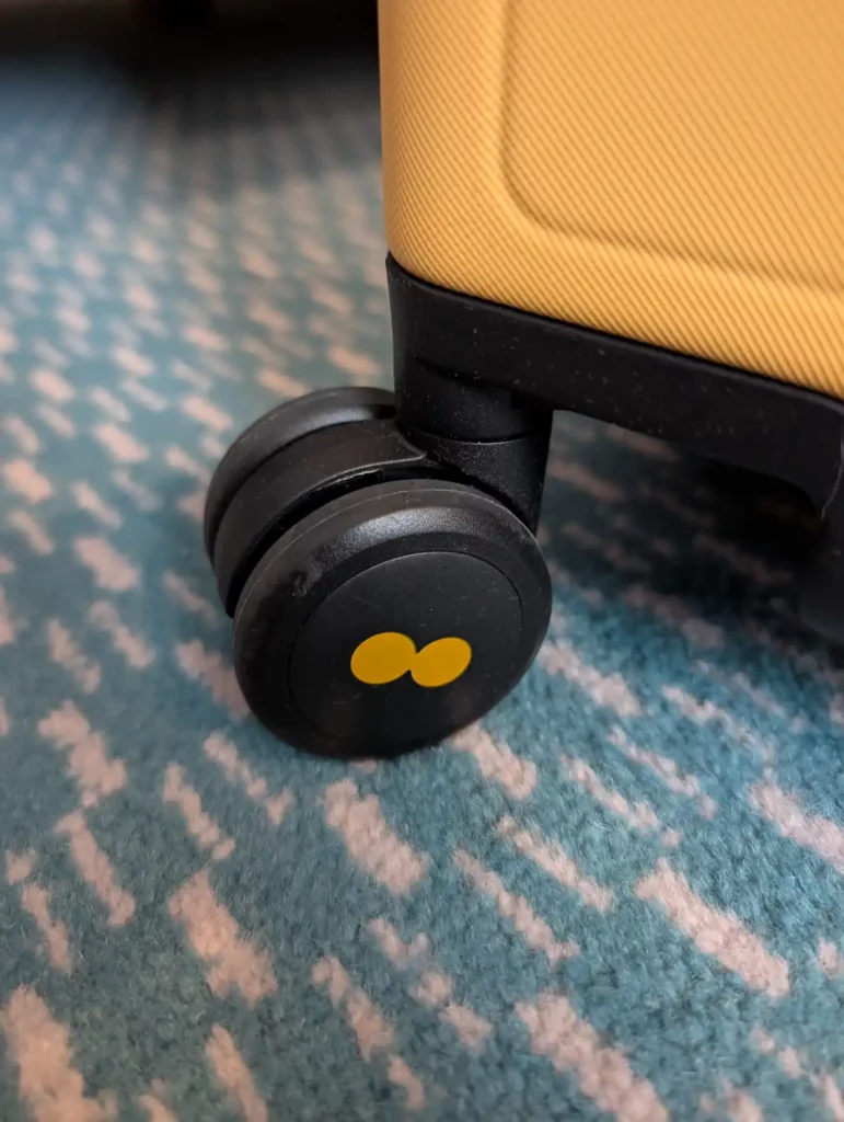 A suitcase wheel on a patterned carpet