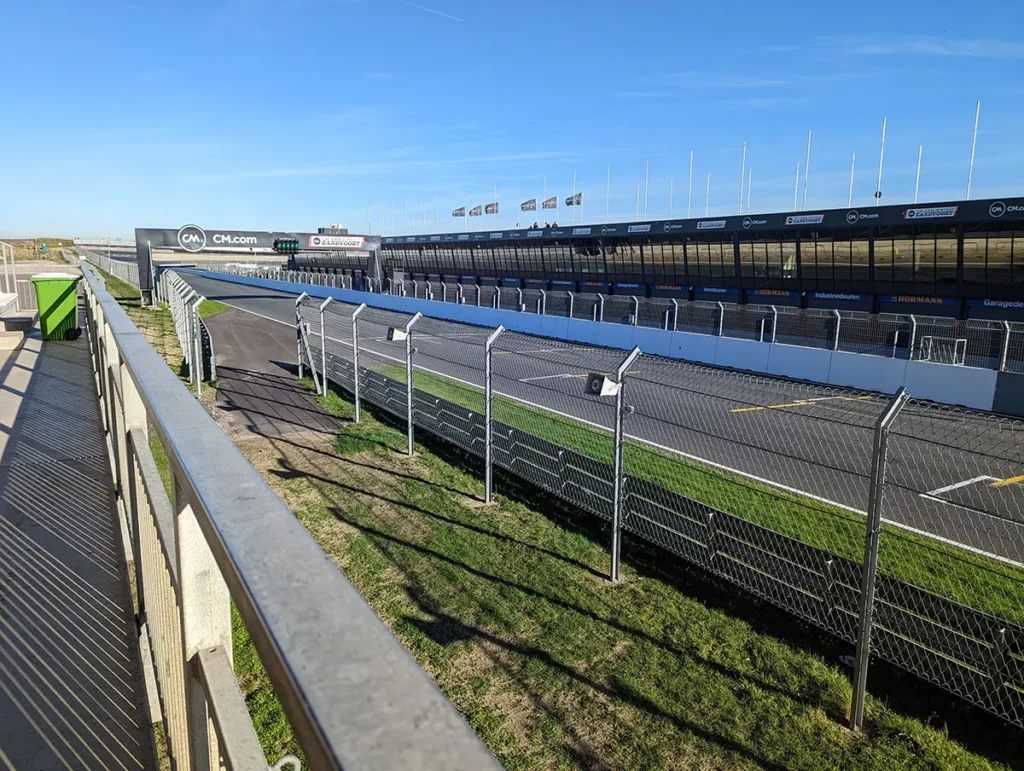 A car racing track with stands and a blue sky