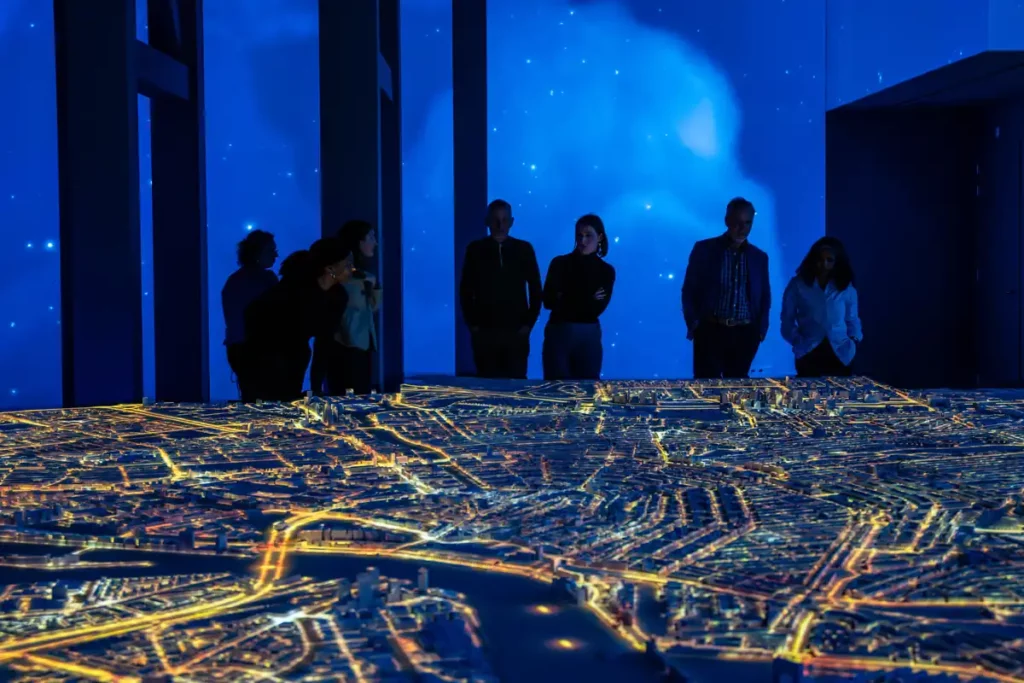 People looking at a giant scale model of Amsterdam