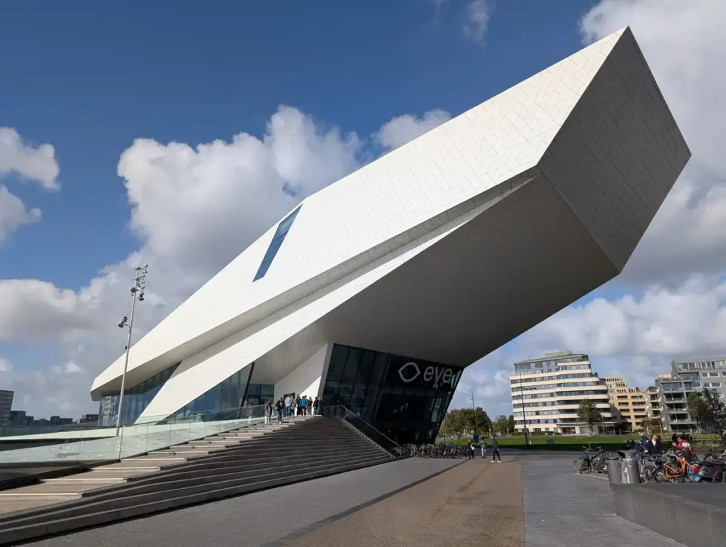 A dramatic sloped white building with an eye logo
