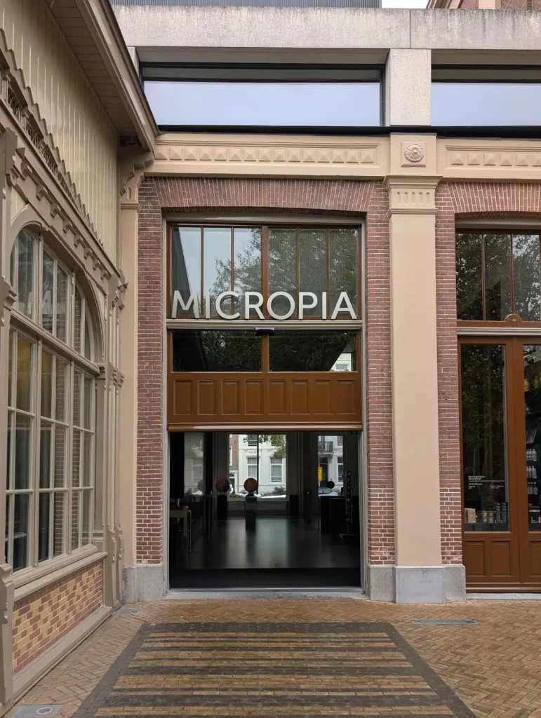 The entrance to ARTIS Micropia. A tall glazed entrance in an old brick building.