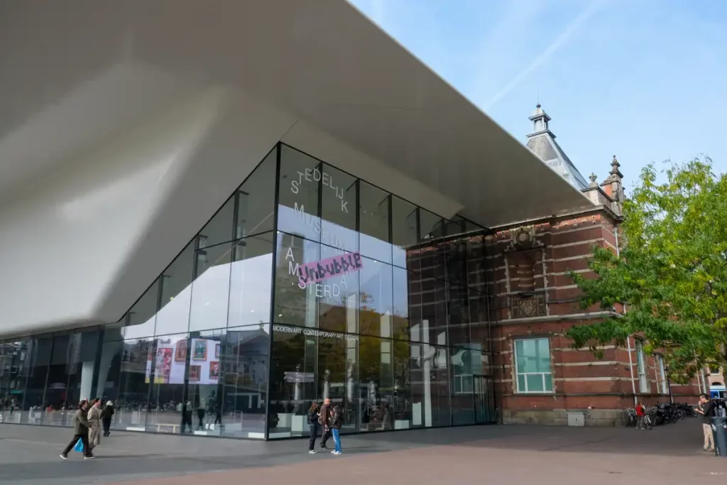 The Stedelijk Museum in Amsterdam has what looks like a giant white bathtub added to the front of a traditional brick building. 