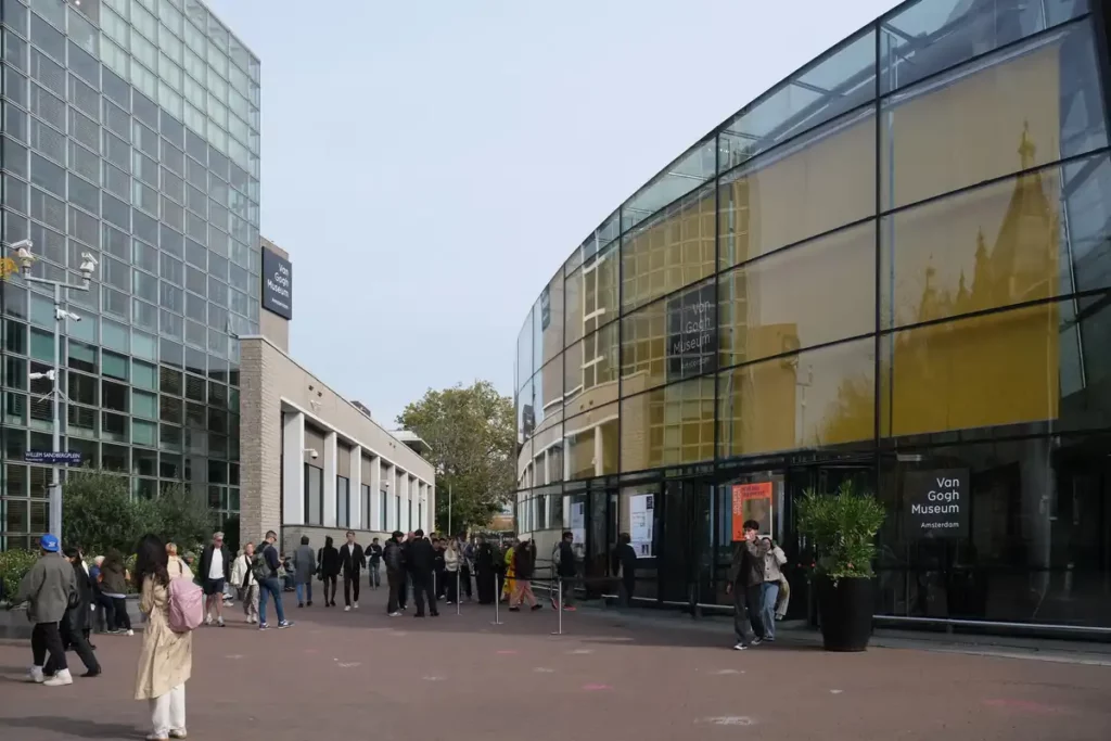 The Van Gogh Museum in Amsterdam. It looks like two modern buildings from the outside, one square, one curved. They connect underground. 