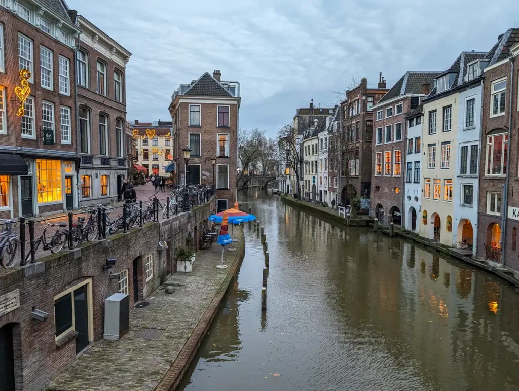 A canal in Utrecht city centre. It's early evening and there are some Christmas lights starting to glow.