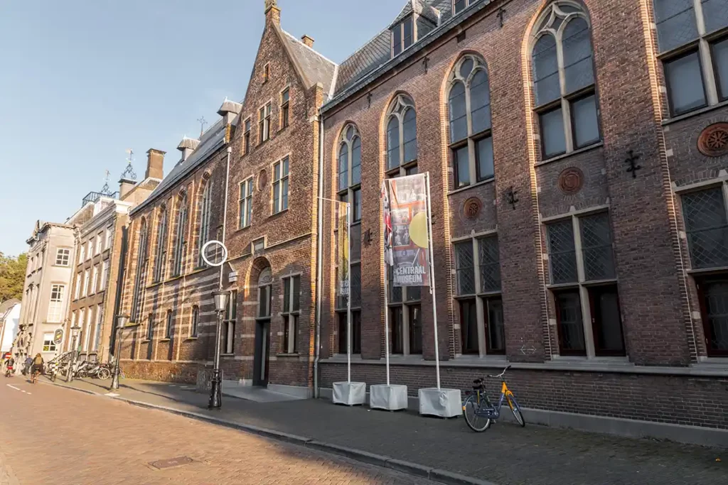 A large, brick building with arched windows on a peaceful street