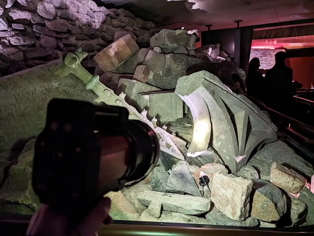 A torch illuminating rubble from a collapsed cathedral