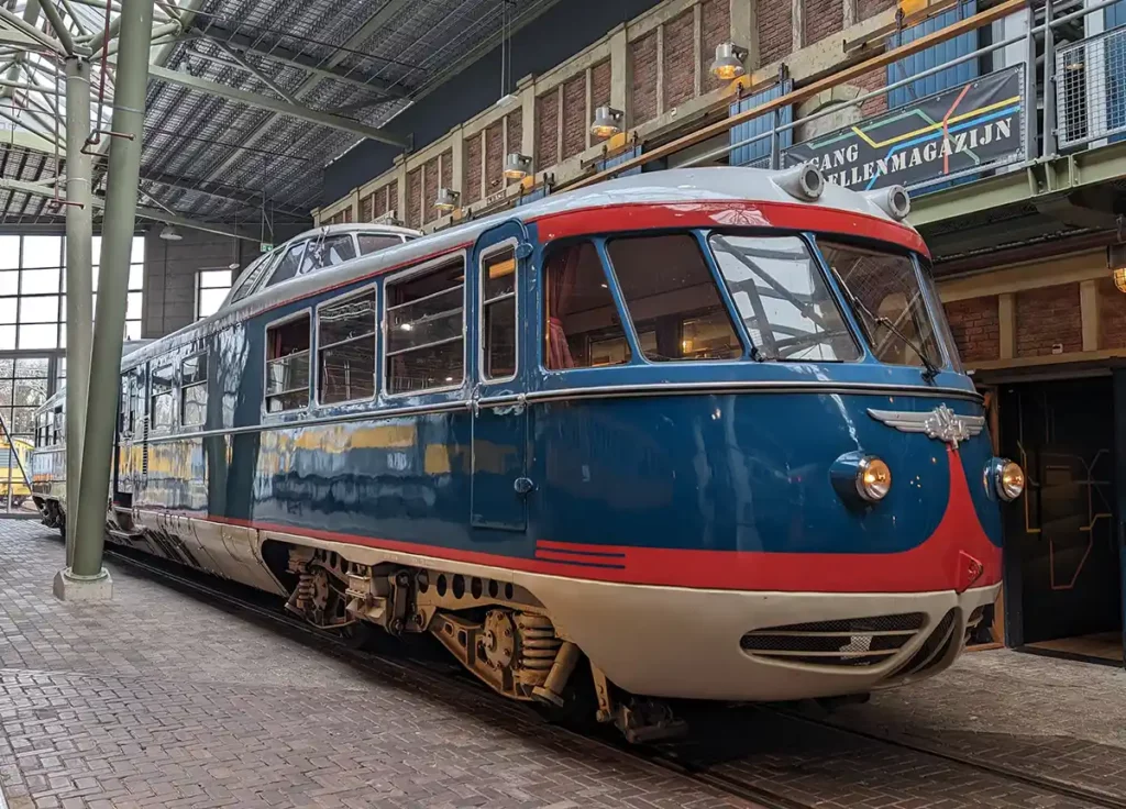 A gorgeous, mid-century railcar, painted in blue, red and white