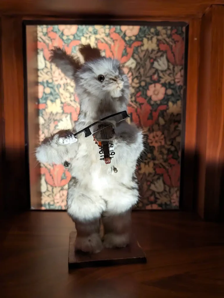 A mechanical white rabbit playing a violin