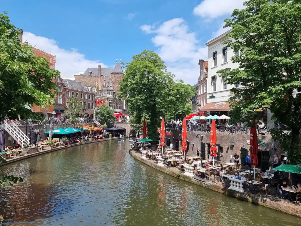 A summer day in Utrecht, with people at cafe tables along the canals
