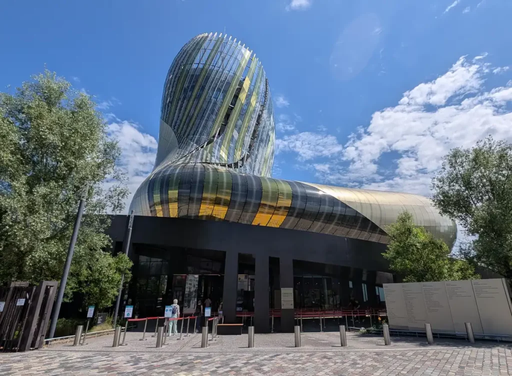 A modern silver building with a rounded, swirling shape