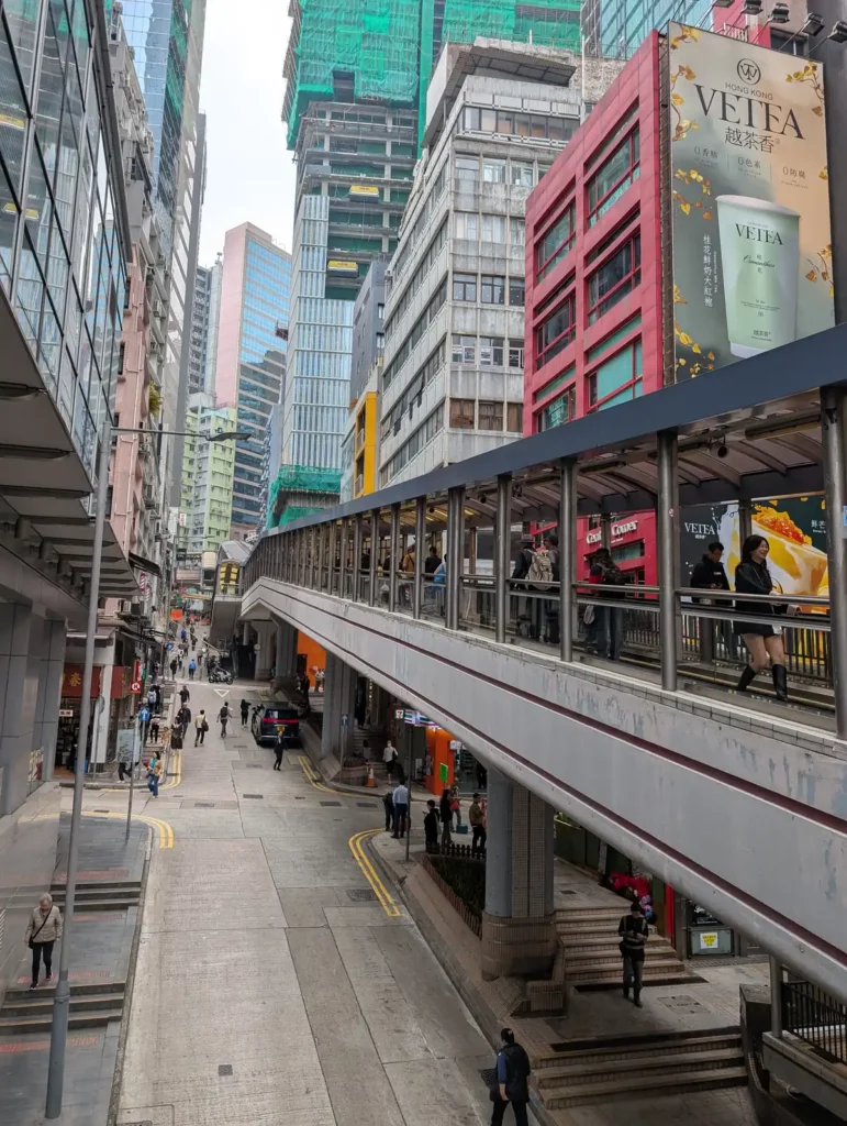 A moving walkway between skyscrapers