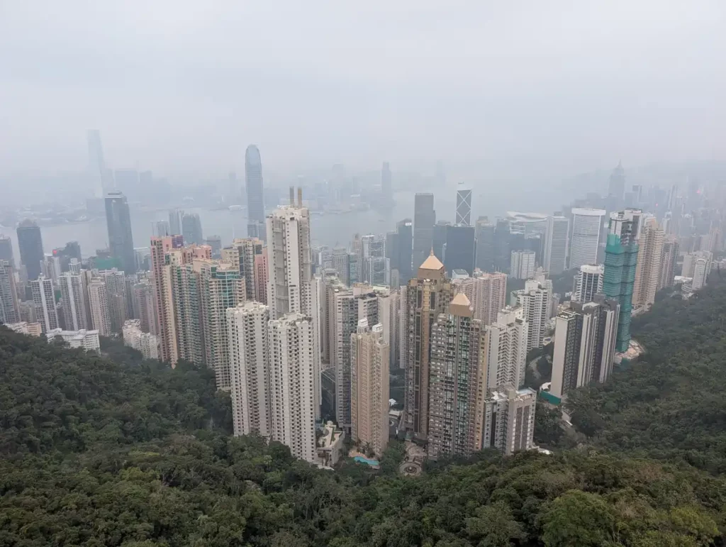 A cloudy view of Hong Kong's skyscrapers and Victoria Harbour from the top of the Peak