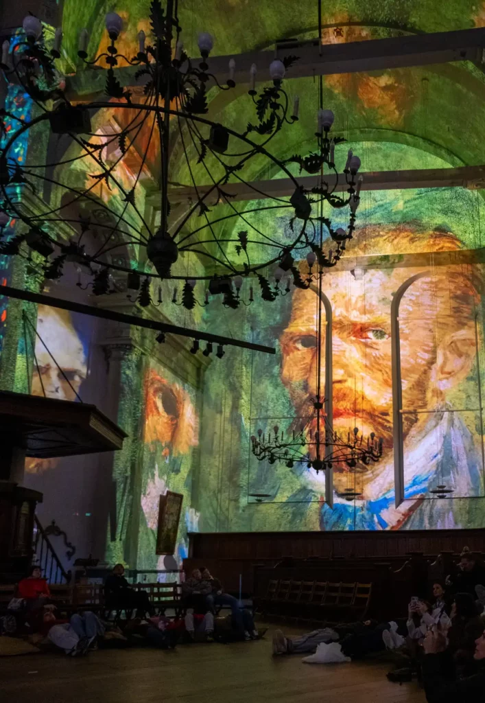 A Van Gogh self-portrait projected on the wall during the Van Gogh and Rembrandt in Amsterdam experience