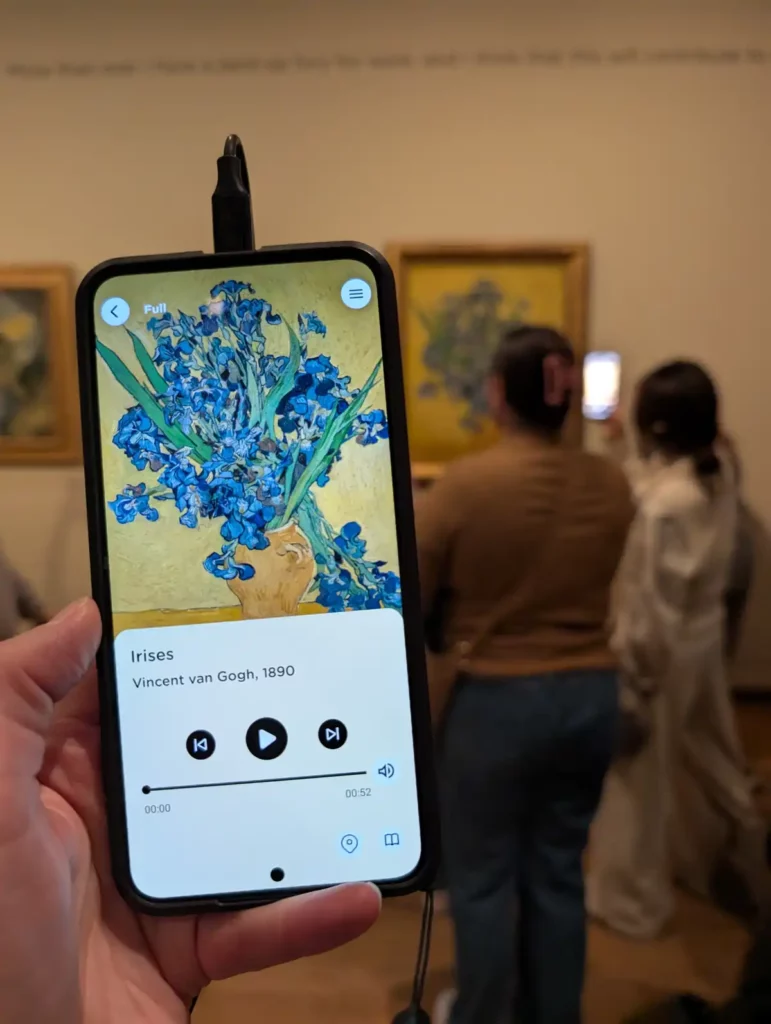 Using the audio guide to find out more about Van Gogh's Irises painting