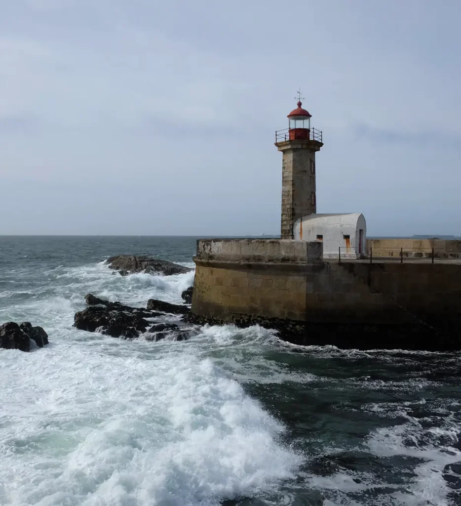 A picturesque lighthouse, with a churning ocean