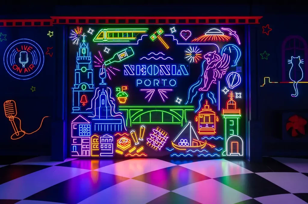 A neon sign at Neonia Porto, showing lots of symbols of the city, including trams, port wine, Clérigos tower and the lighthouse at Foz