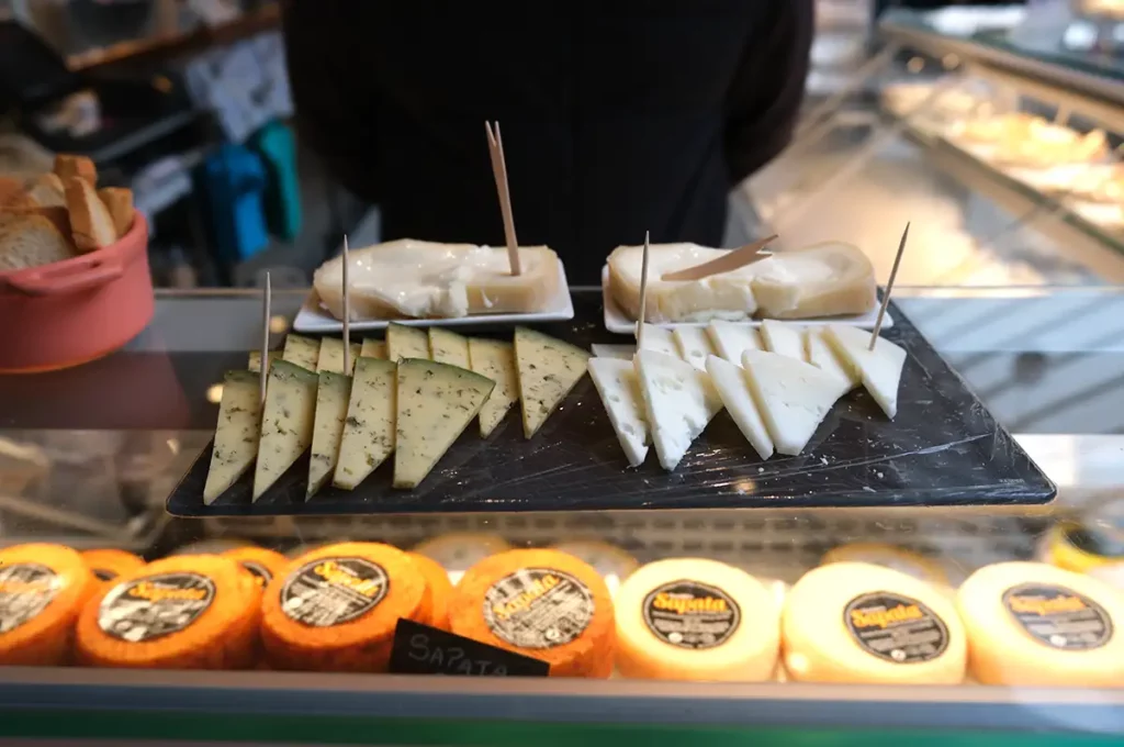 Some cheeses ready to be sampled at a market stall