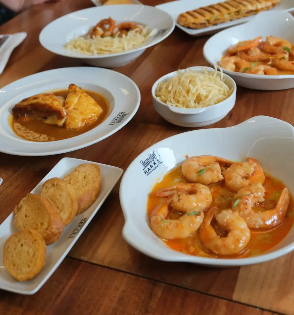 A range of traditional Portuguese dishes on a table at the Time Out Market food hall in Porto