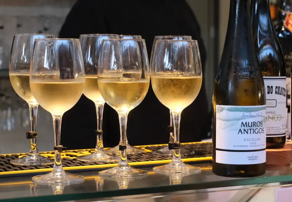 Six glasses of Vinho Verde on a market stall counter