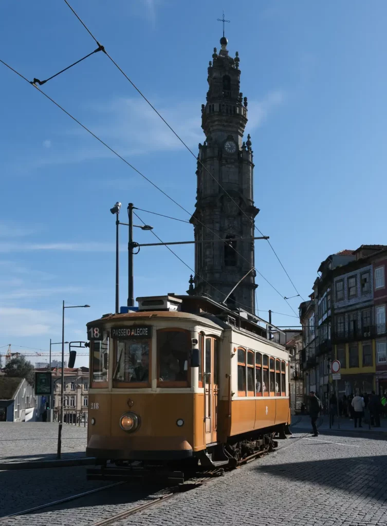 A vintage tram in front of Clérigos Tower