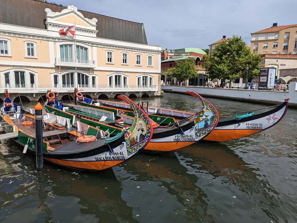 Traditional painted boats on a canal in Aveiro, one of the best day trips from Porto