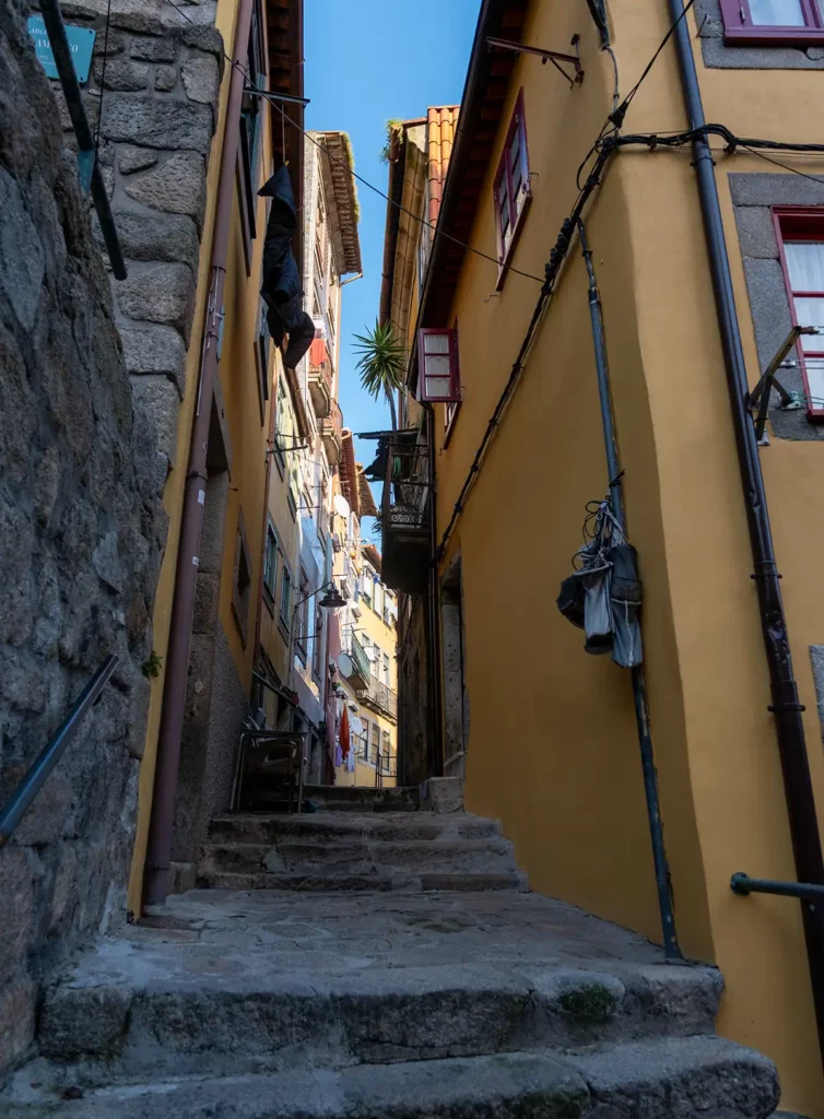 Stairs on a narrow street between historic, brightly painted houses