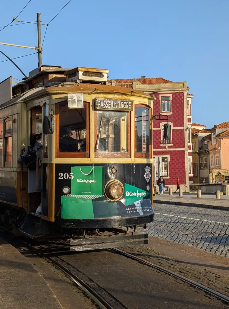 A vintage tram in front of old buildings in Porto
