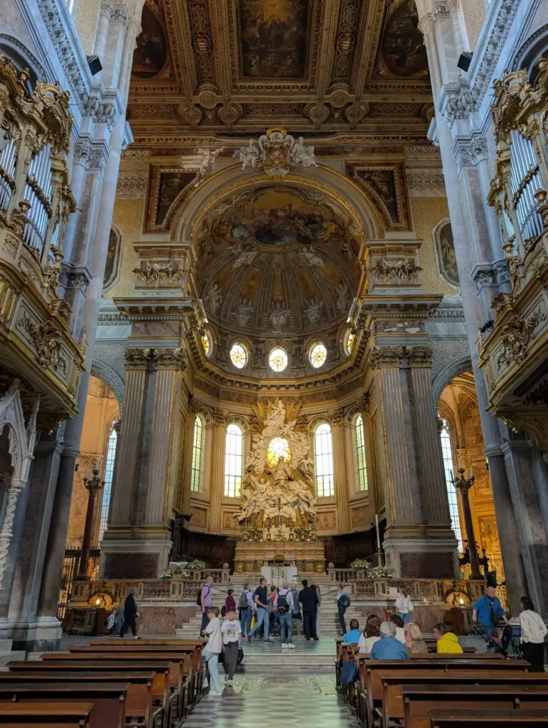 The inside of a large, grand Catholic church with lots of decoration