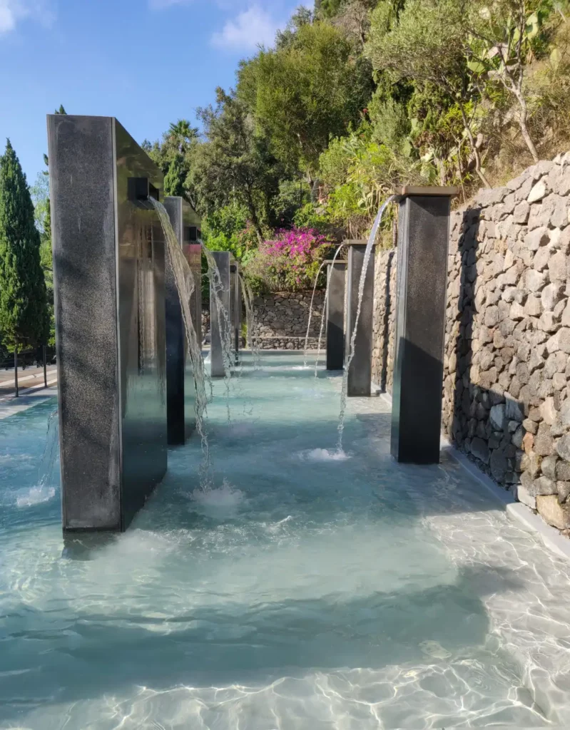 One of the treatment areas at the Negombo thermal spa in Ischia. Metal columns have spa water coming out of them like a shower.