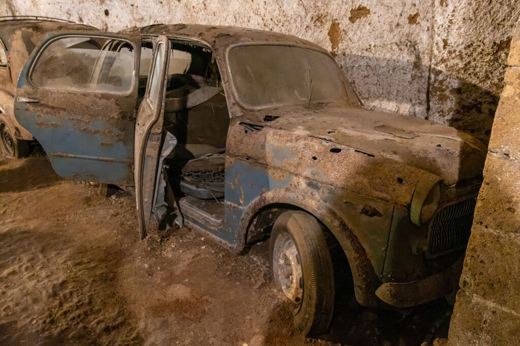 A blue, vintage car, abandoned in the Galleria Borbonica