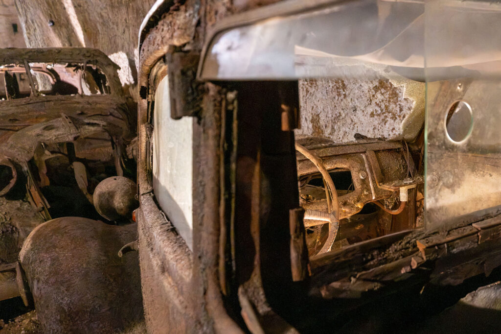 Looking through the window of one of the abandoned cars. You can see the steering wheel and dashboard.