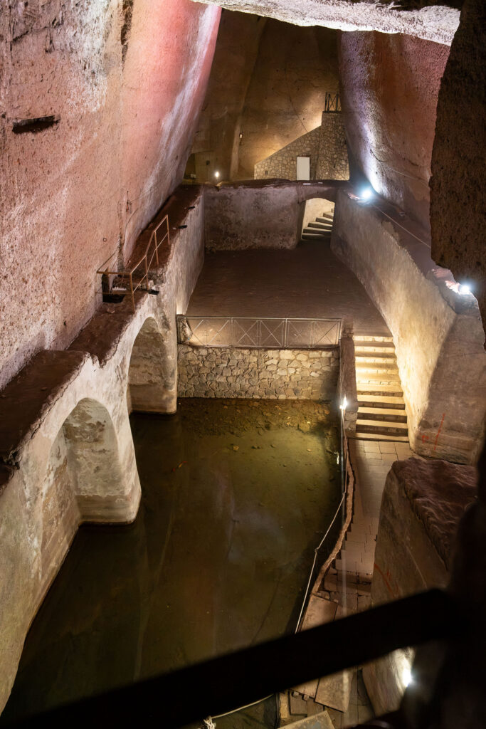 A series of water chambers with stairs connecting them. Some still have water still in them.